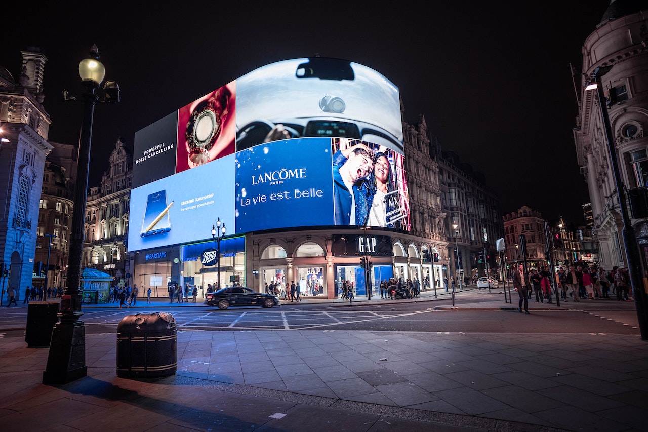 Ville nocturne avec affichage publicitaire et piétons